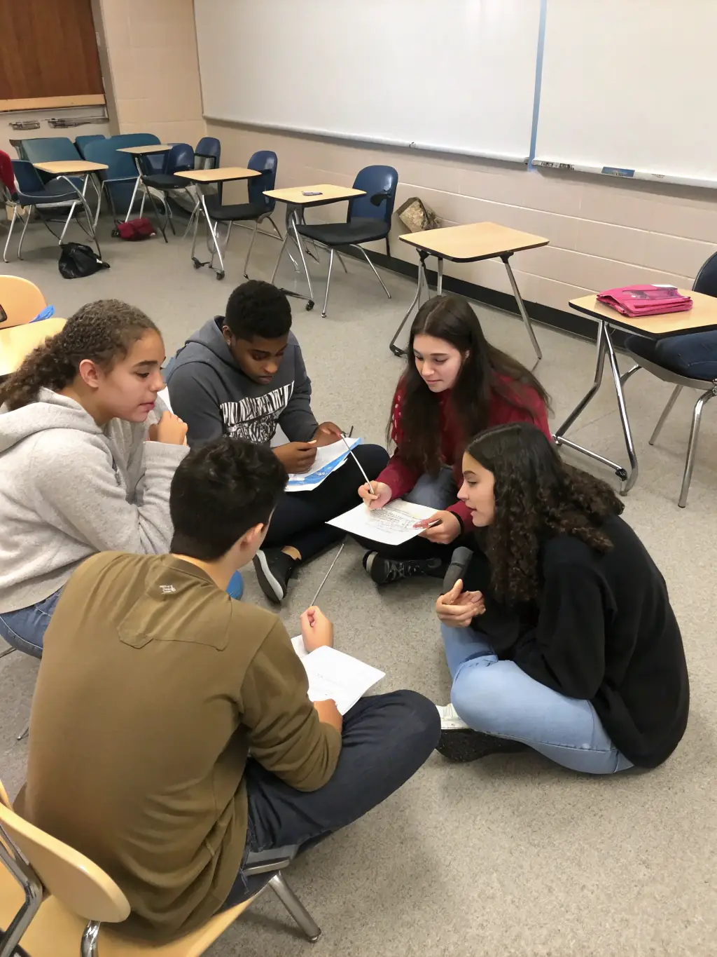 A picture of students participating in a peer mediation session, resolving conflicts peacefully and promoting a positive school environment.